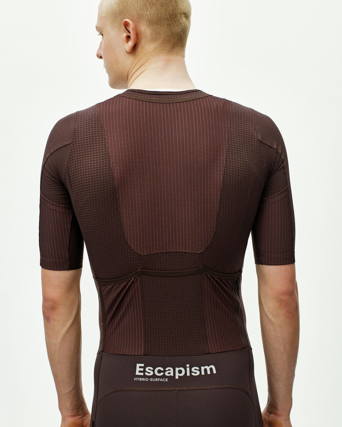 Dark Red Escapism speedsuit on model, rear view showing textured fabric and chest panel construction #Color_Dark Red