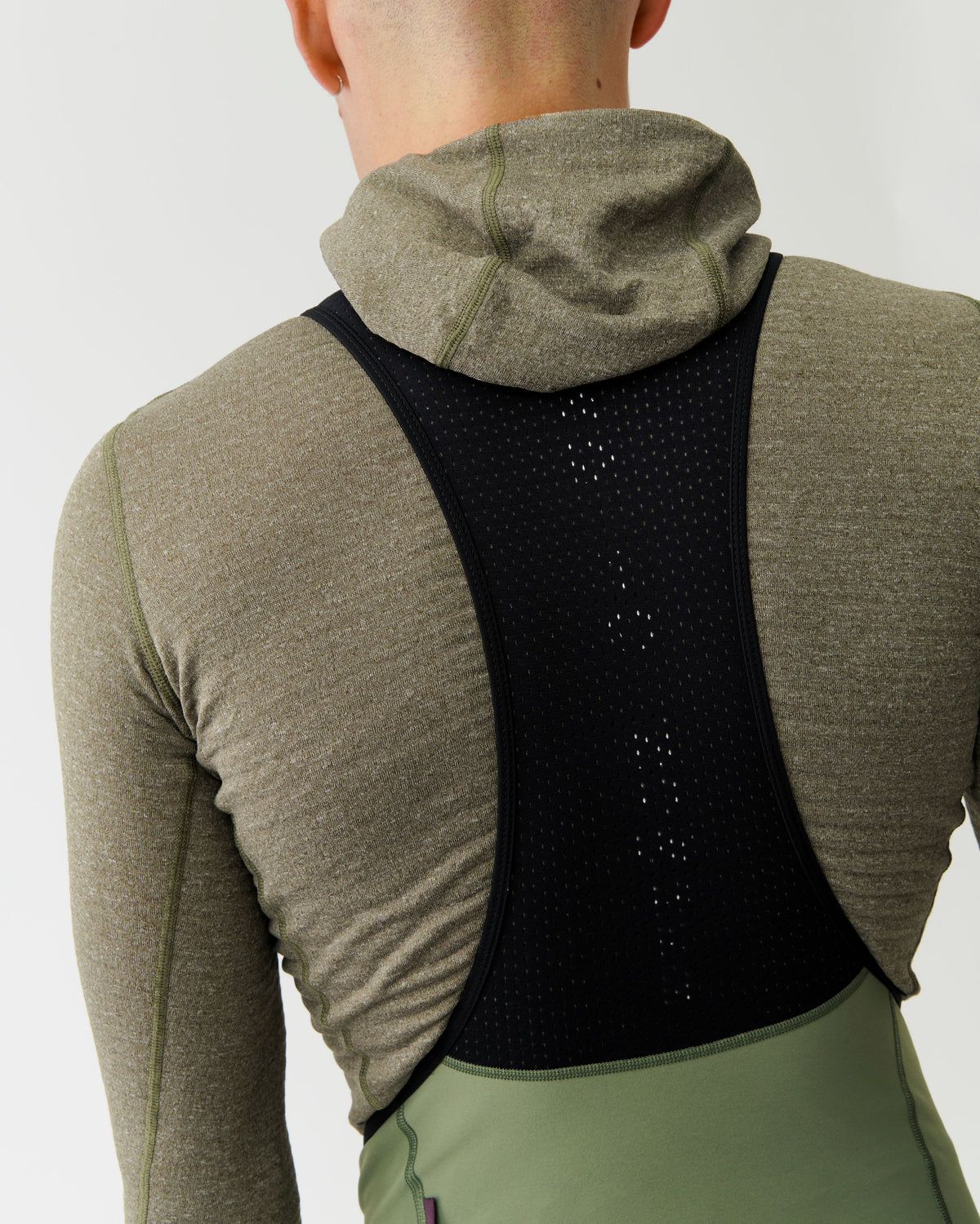 Grey Thermal Hooded Windproof base layer on model, rear view with black perforated back panel #Color_Dark Stone