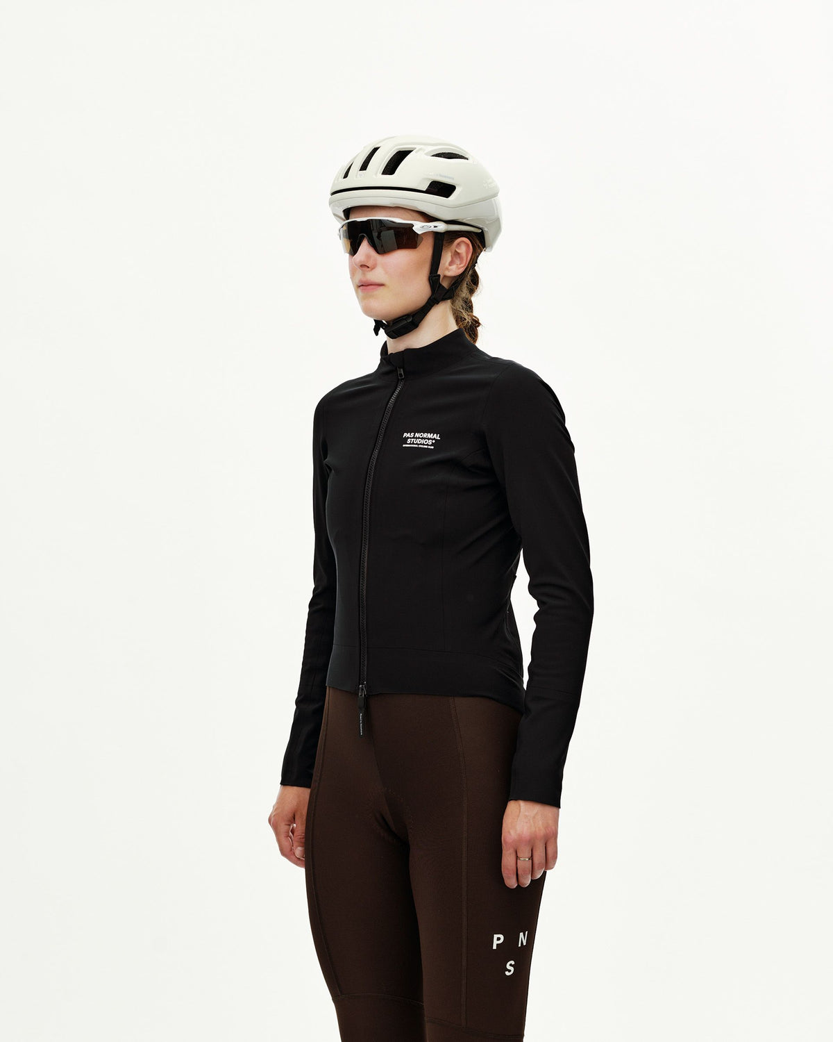 Black Mechanism Thermal women's cycling jacket on model, three-quarter front view with full zip and white chest logo #Color_Black