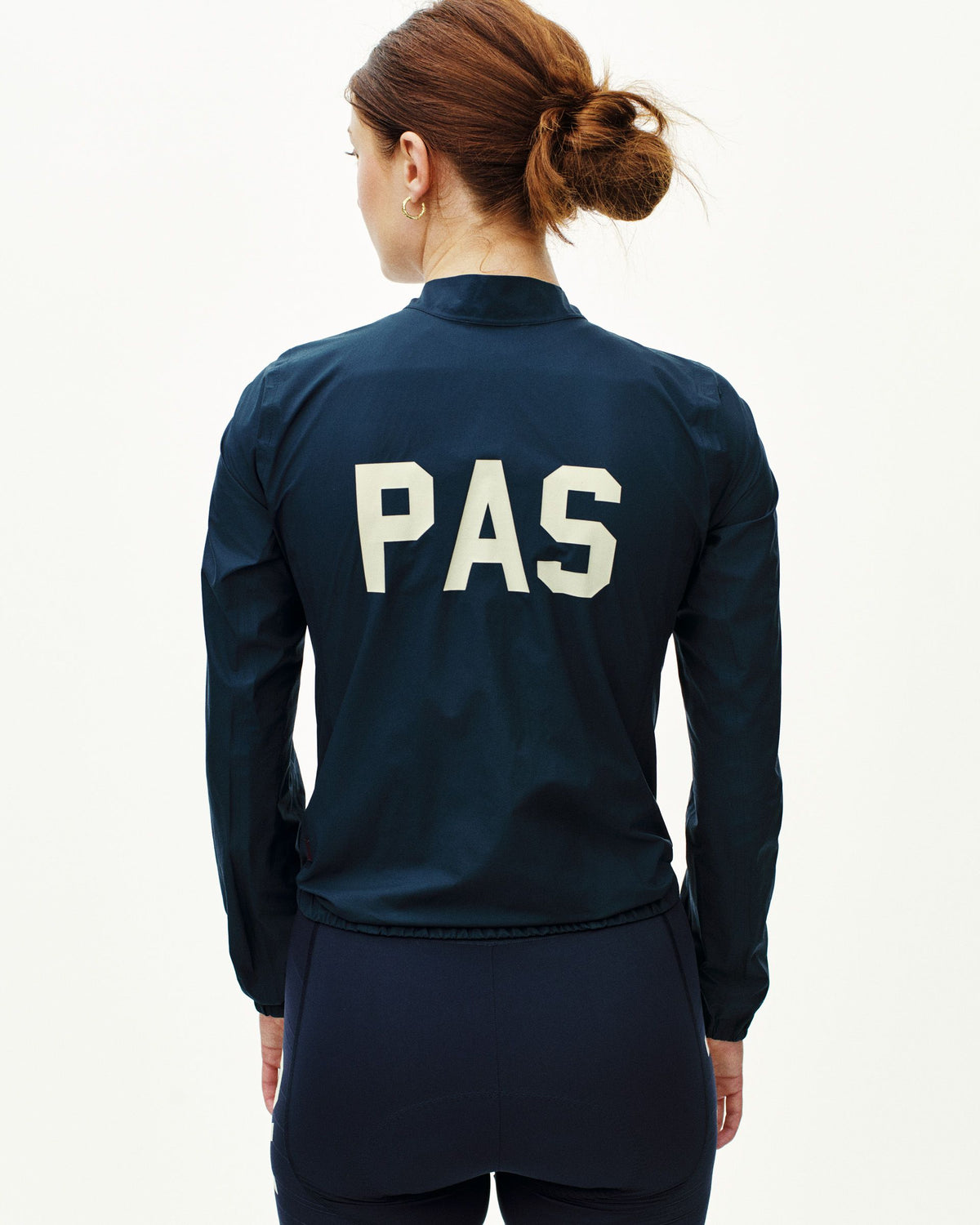 Navy PAS Mechanism rain jacket on model, rear view with white PAS logo #Color_Navy