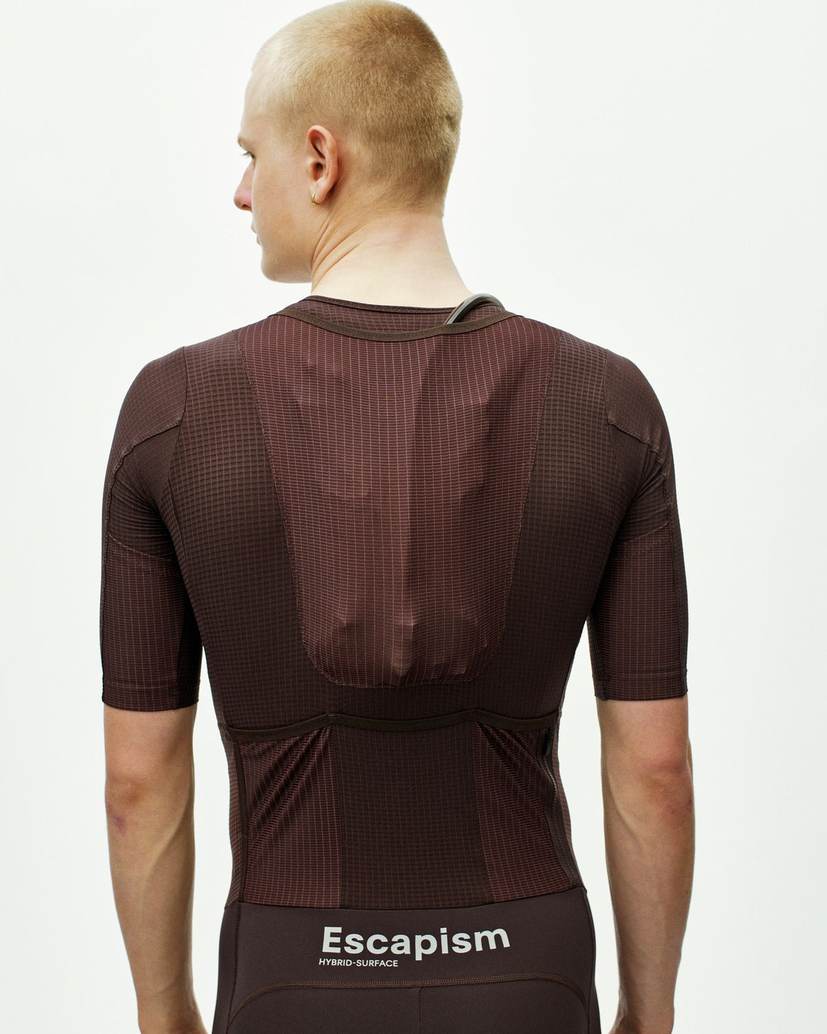 Dark Red Escapism men's cycling speedsuit, rear view on model with grid texture panel #Color_Dark Red