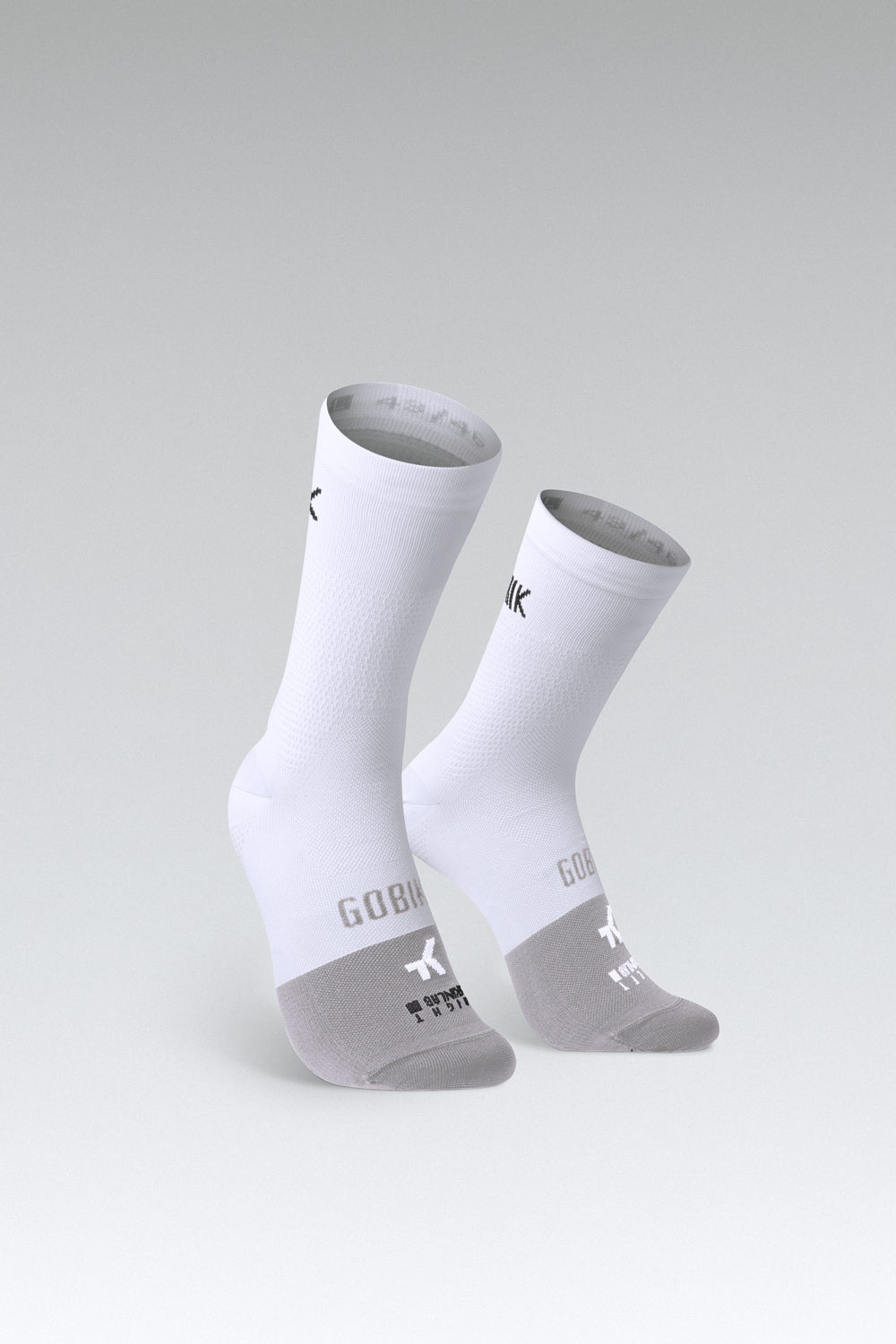 Calcetines Gobik Lightweight 2.0 en Salt, bodegón del par de calcetines blancos con el pie gris sobre fondo de estudio #Color_Salt