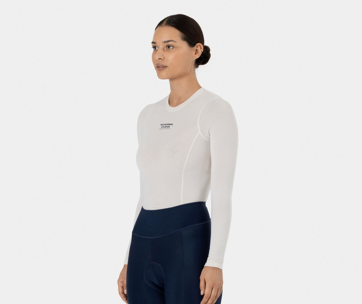 Off White Thermal Long Sleeve base layer on model, three-quarter view with black chest logo #Color_Off White