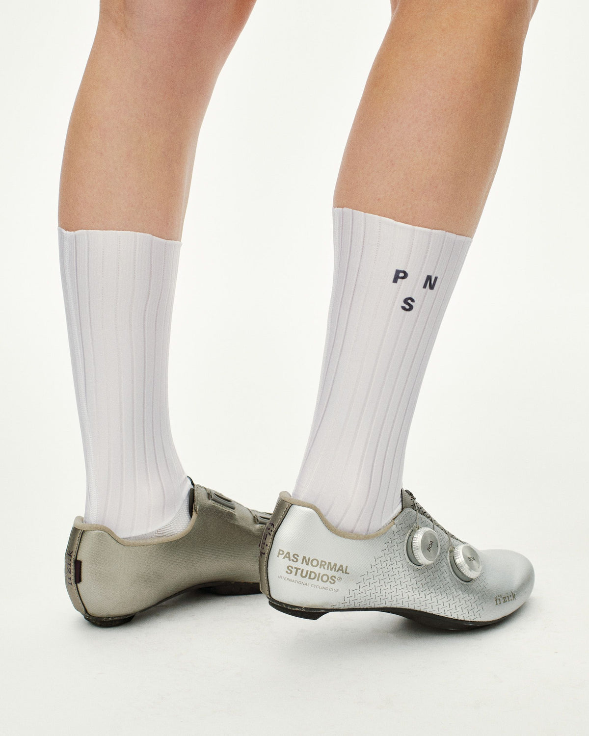 White Aero cycling socks on model with ribbed texture and black lettering #Color_White