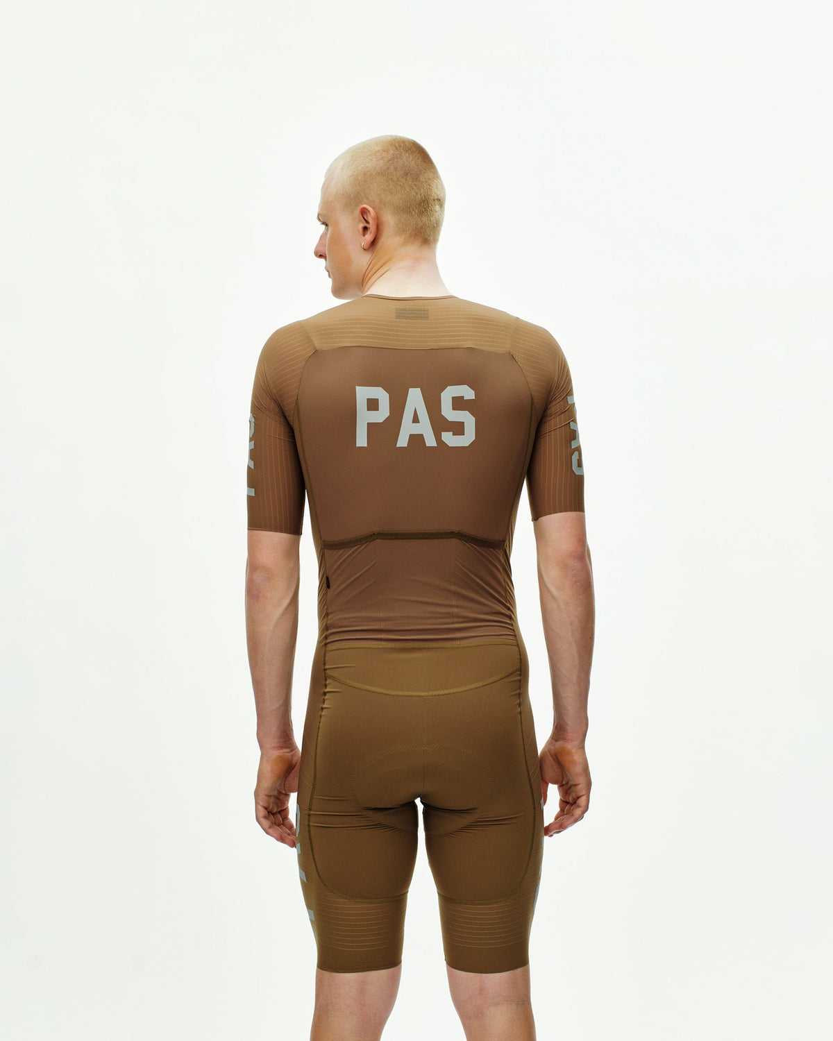 Brown PAS Mechanism Pro speedsuit, rear view on model with white PAS back print #Color_Brown