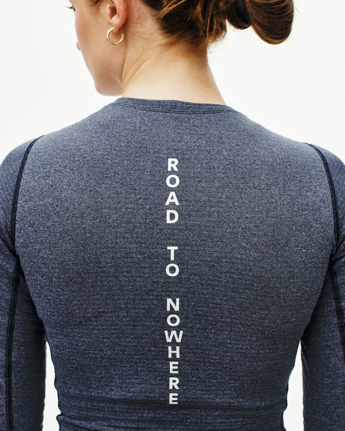 Navy thermal long sleeve base layer on model, rear view with white vertical spine text #Color_Navy