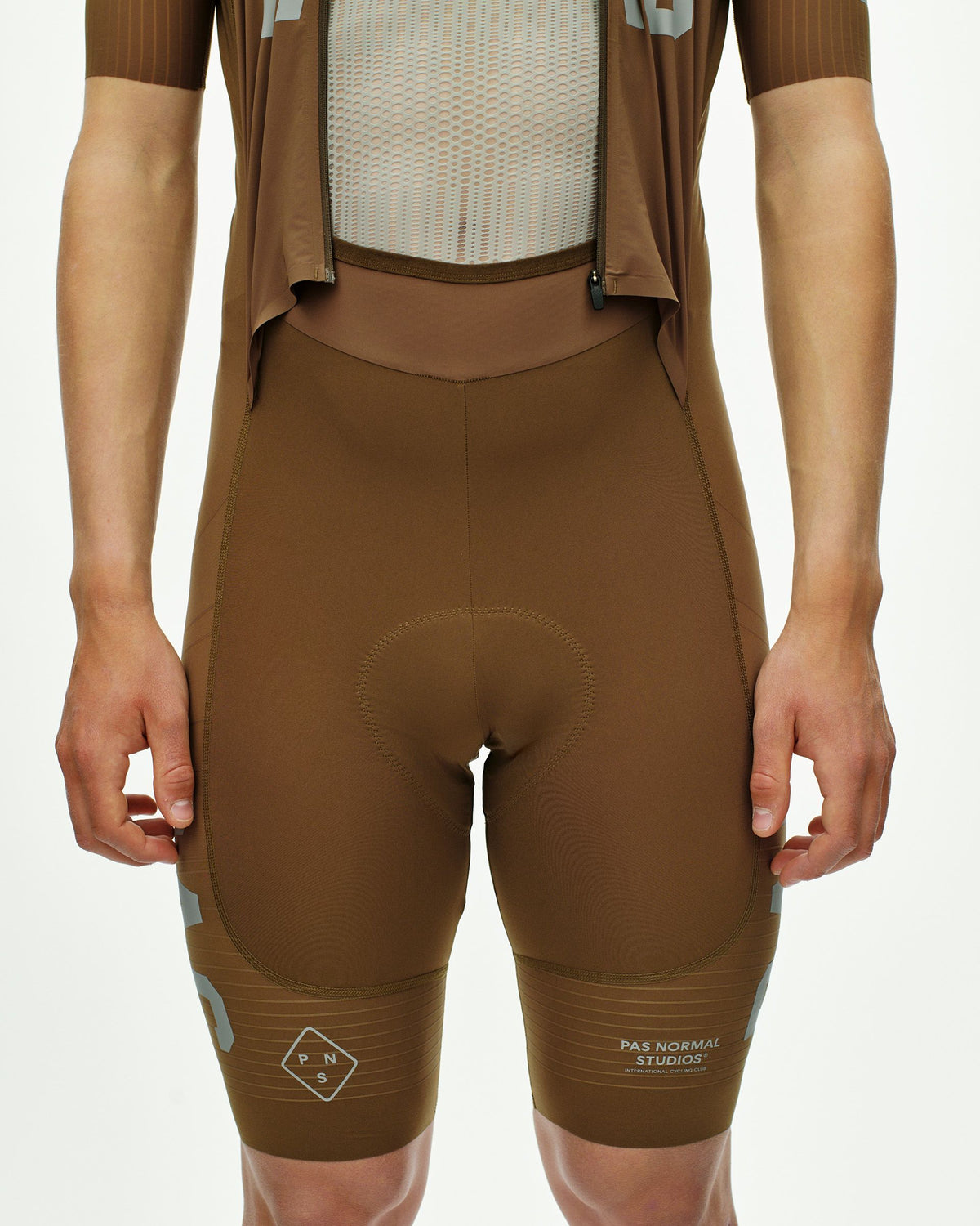 Brown PAS Mechanism Pro speedsuit, front view on model with mesh chest panel and contrast stitching #Color_Brown