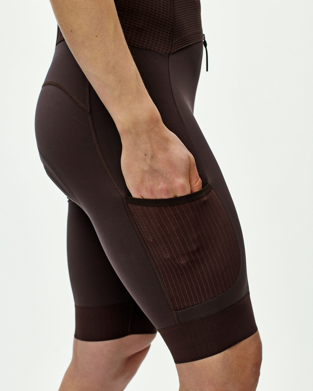 Dark Red Escapism speedsuit on model showing side thigh pocket with grid texture panel #Color_Dark Red