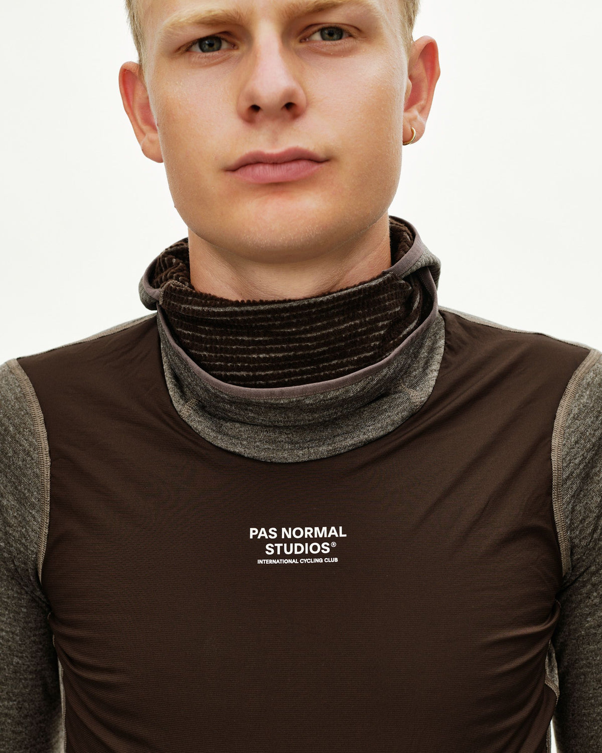 Dark Coffee brown cycling base layer on model, front detail view with ribbed turtleneck collar and white chest logo #Color_Dark Coffee