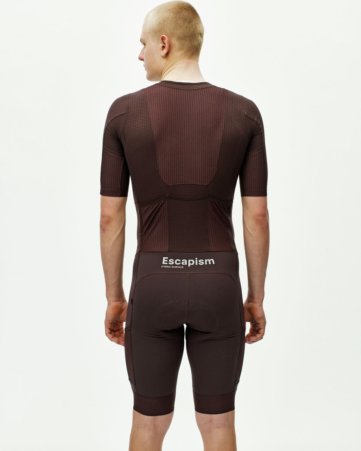 Dark Red Escapism cycling speedsuit, rear view on model with ribbed texture panels #Color_Dark Red