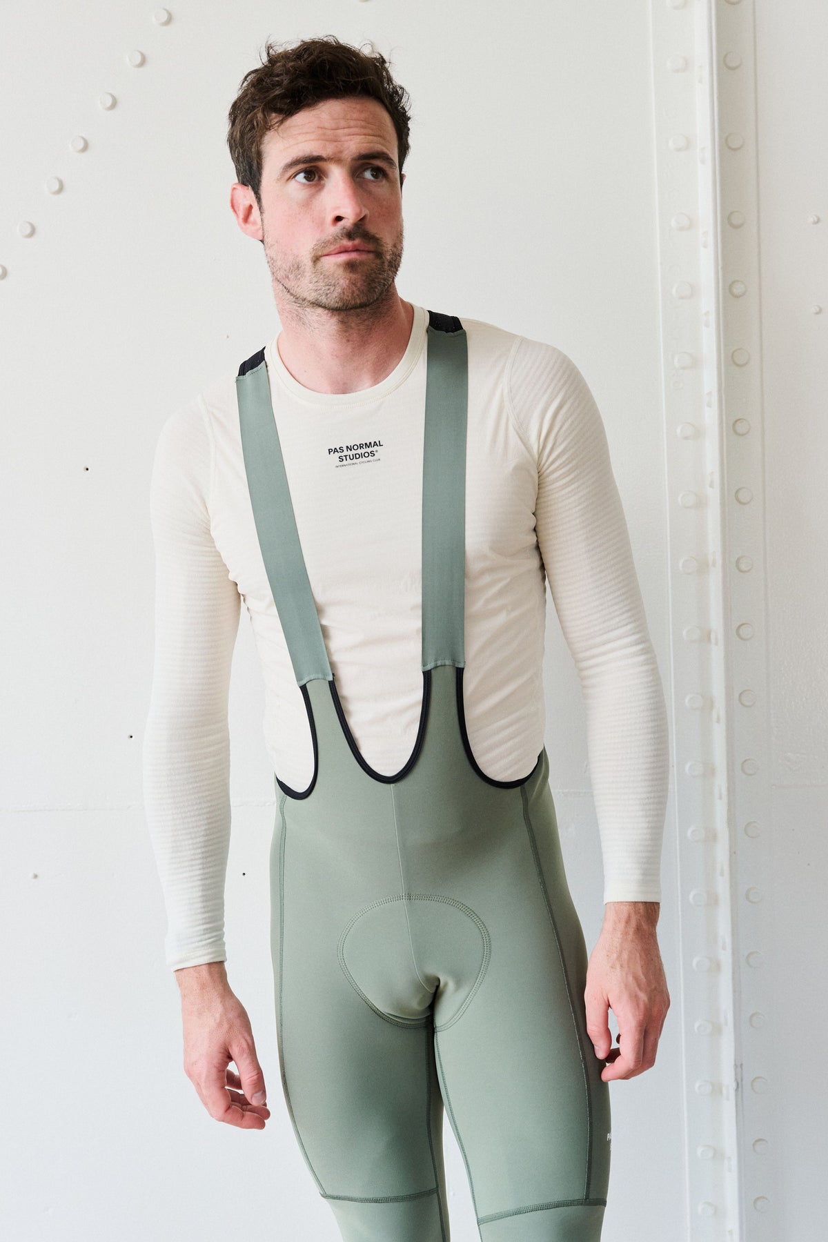 Off White Thermal Windproof base layer on model with textured sleeves and chest logo #Color_Off White