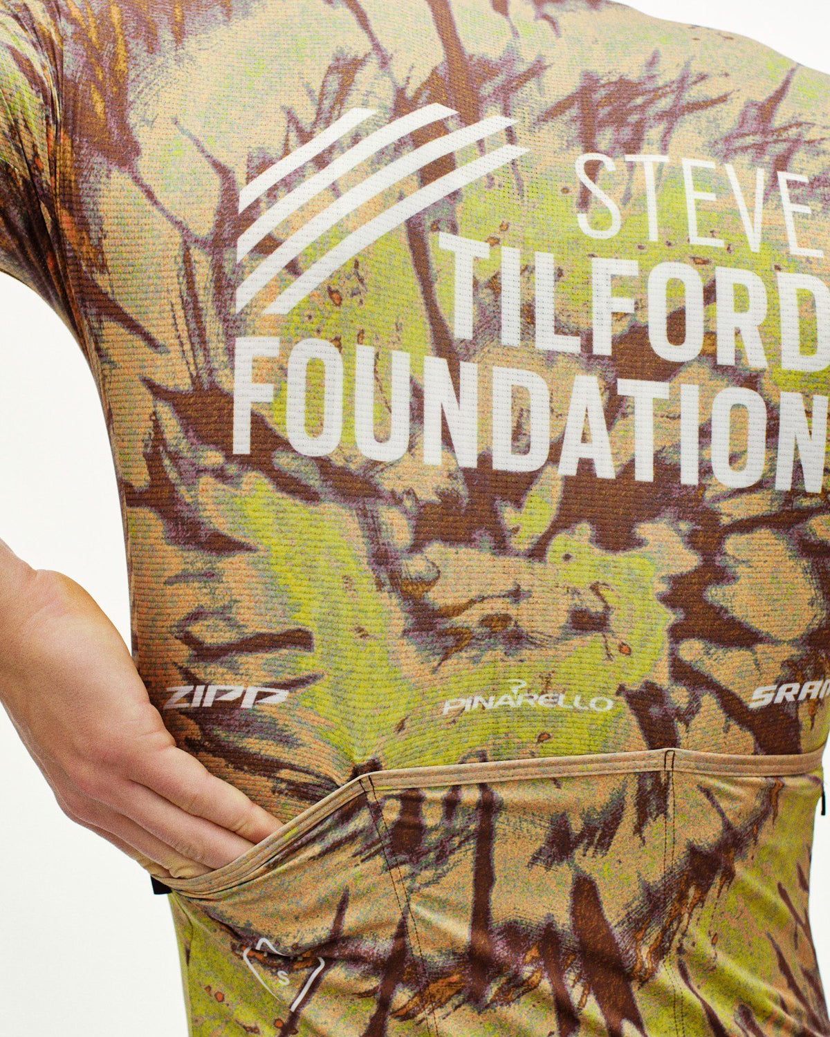 Beige STFR Mechanism long sleeve speedsuit on model with camouflage print and white chest logo #Color_STFR Beige