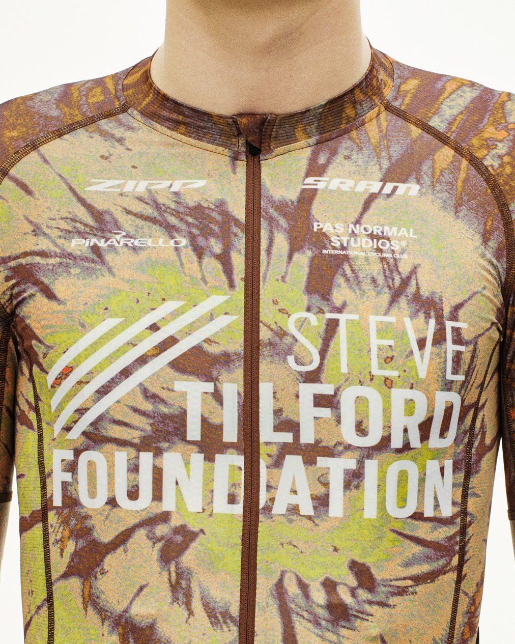 Beige STFR Mechanism long sleeve speedsuit, front view on model with camouflage print and Steve Tilford Foundation branding #Color_STFR Beige