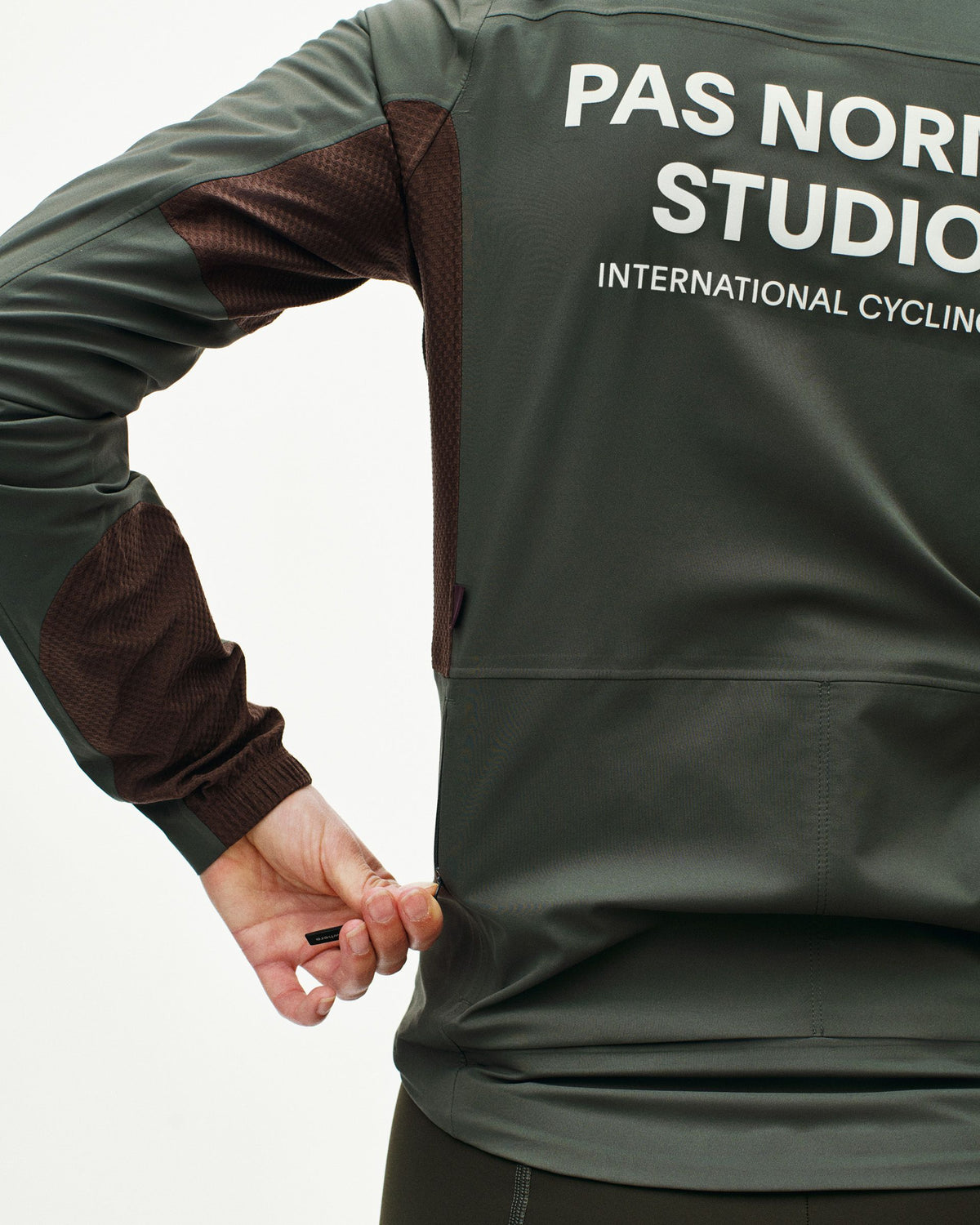Dark Grey Mechanism Shell cycling jacket on model with brown contrast sleeves #Color_Dark Grey