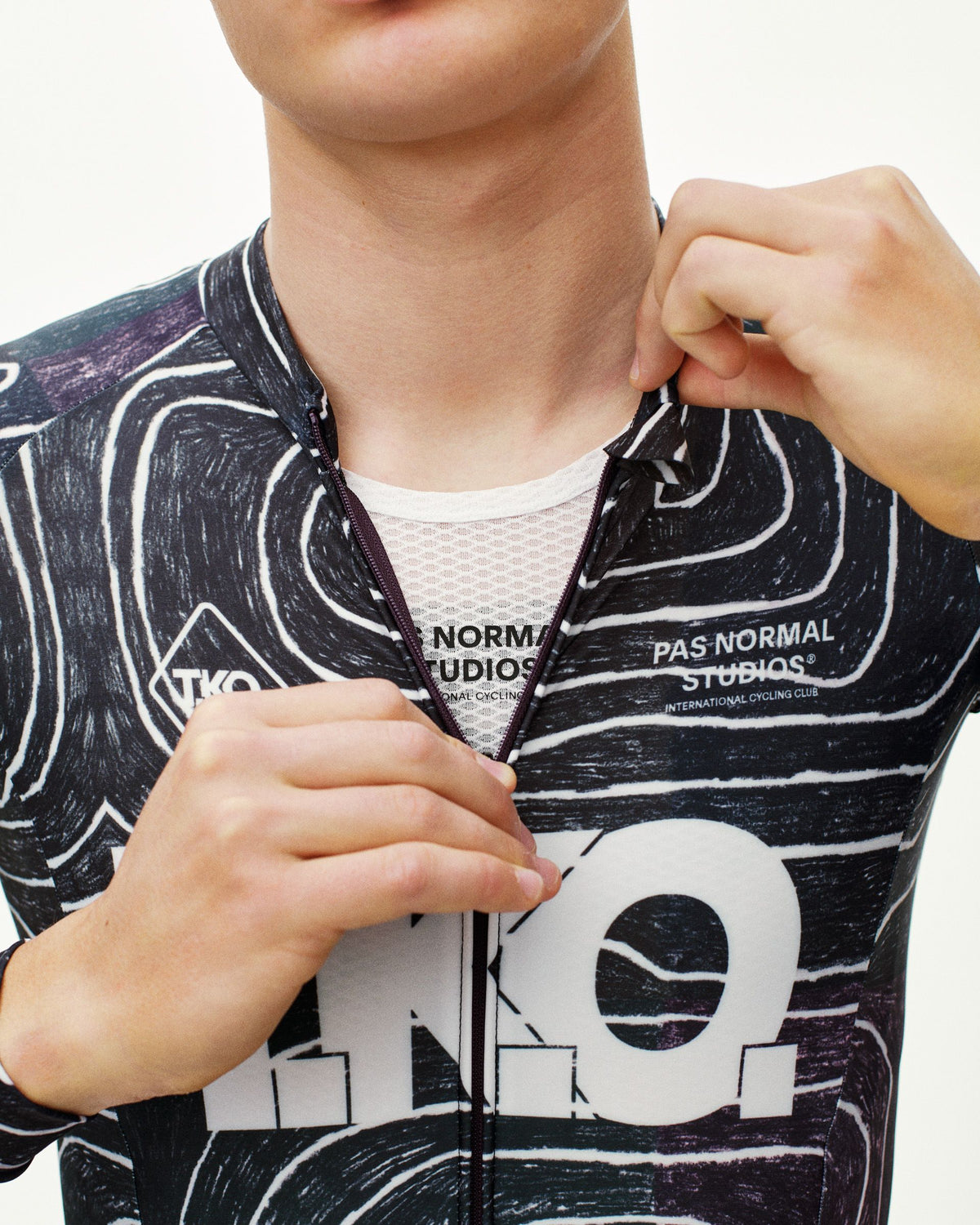 Black T.K.O. Thermal speedsuit on model, front zip detail with all-over graphic print #Color_T.K.O. Black Multi