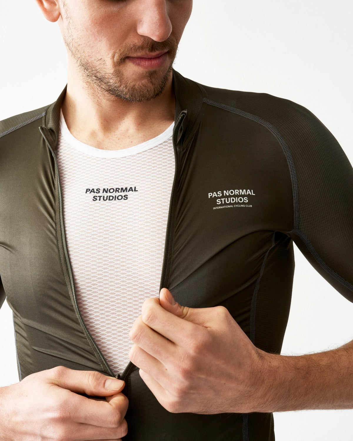 Maillot Corto Pas Normal Studios Mechanism en Dark Olive, vista frontal sobre ciclista #Color_Dark Olive