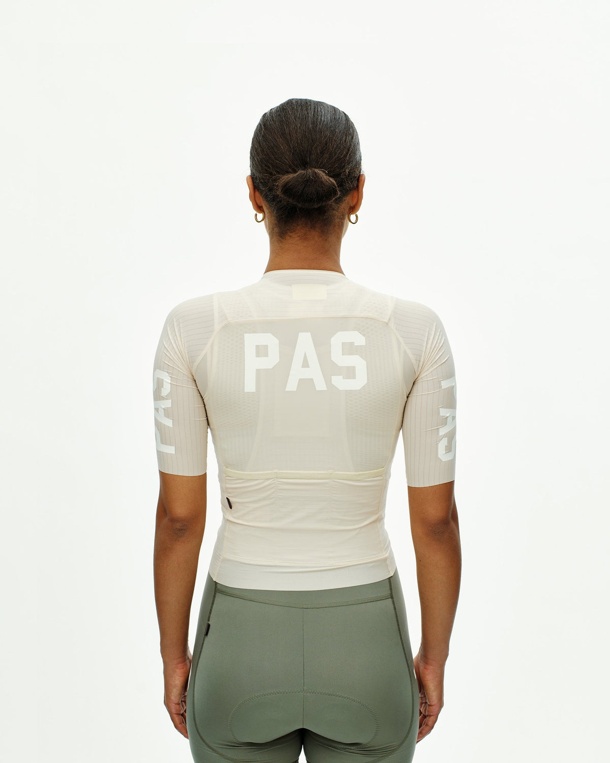 Maillot Mujer Pas Normal Studios PAS Mechanism Pro en Cream, sobre ciclista, vista trasera #Color_Cream