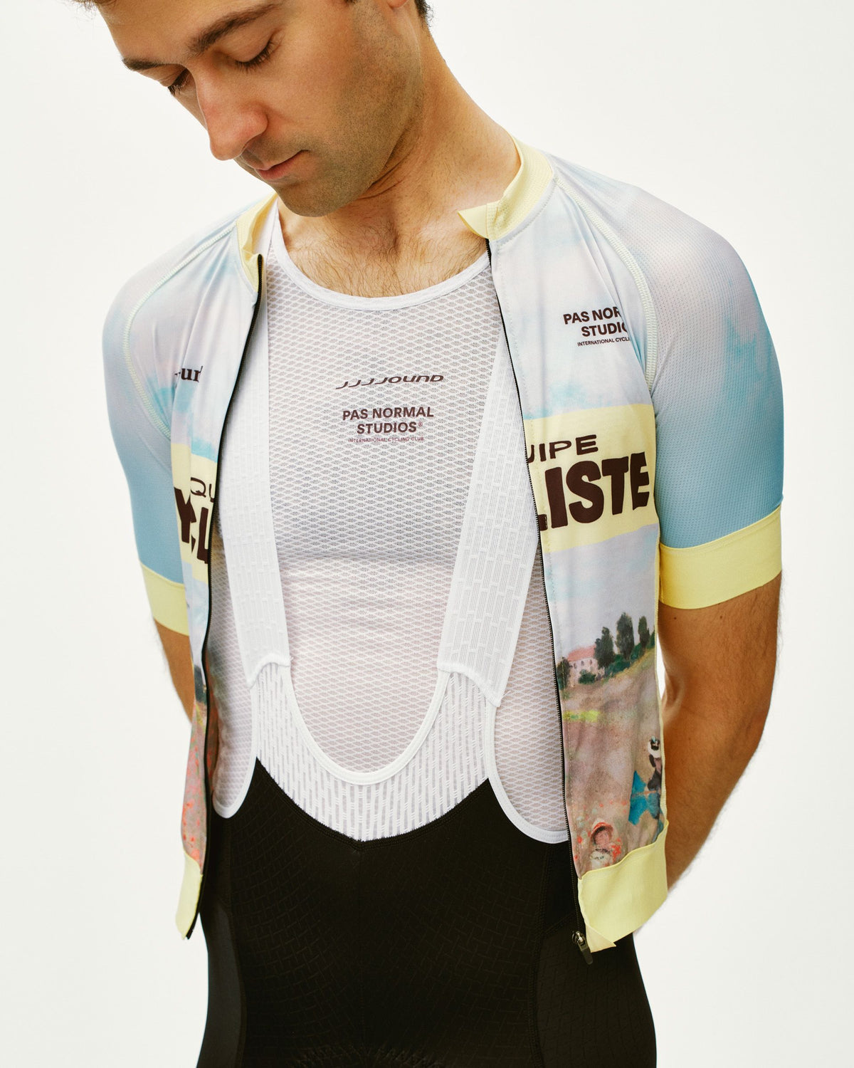 White JJJJound sleeveless base layer on model with mesh construction and branded chest print #Color_White