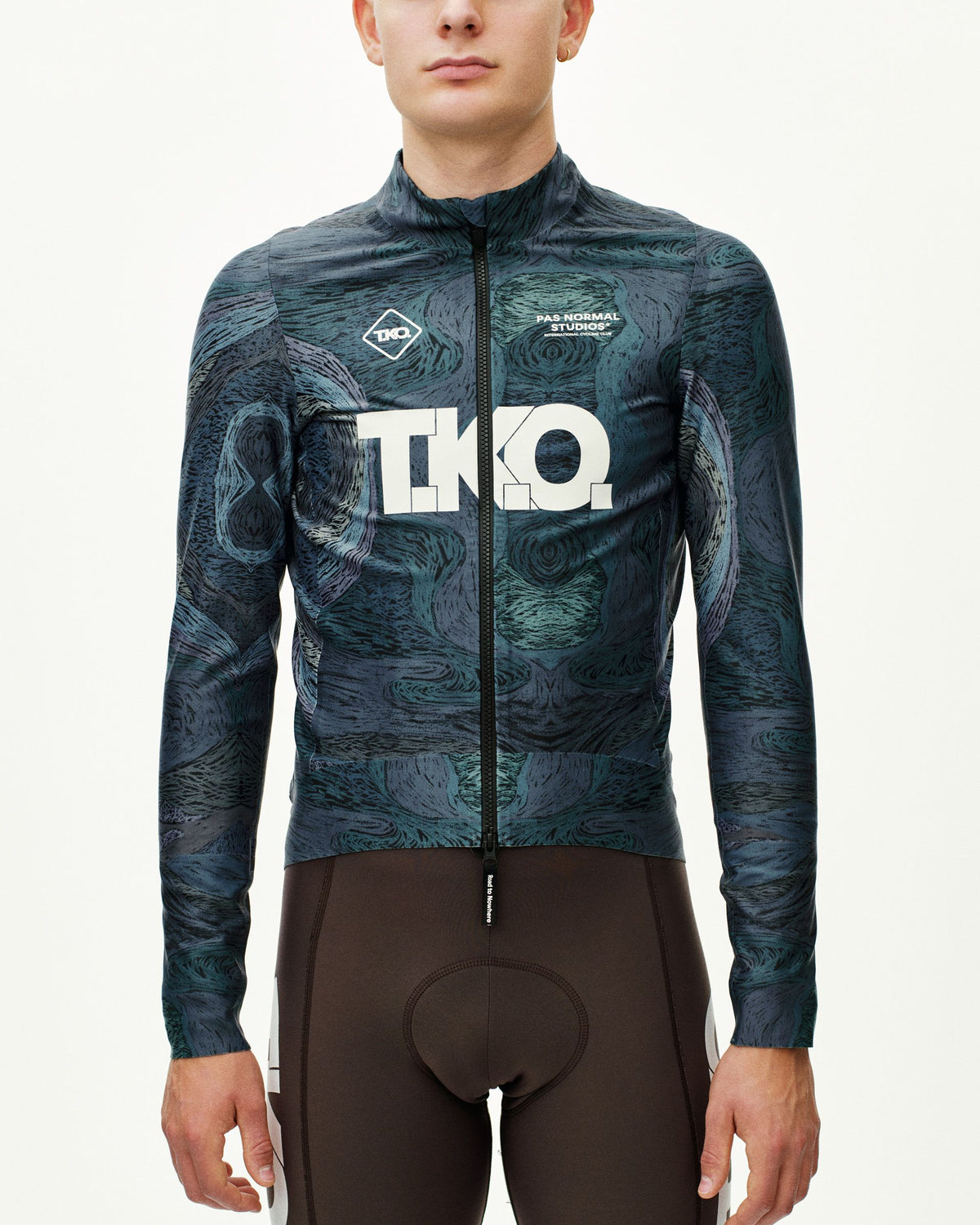 Dark Multi T.K.O. Mechanism Thermal cycling jacket on model, front view with allover swirl print and white chest logo #Color_T.K.O. Dark Multi