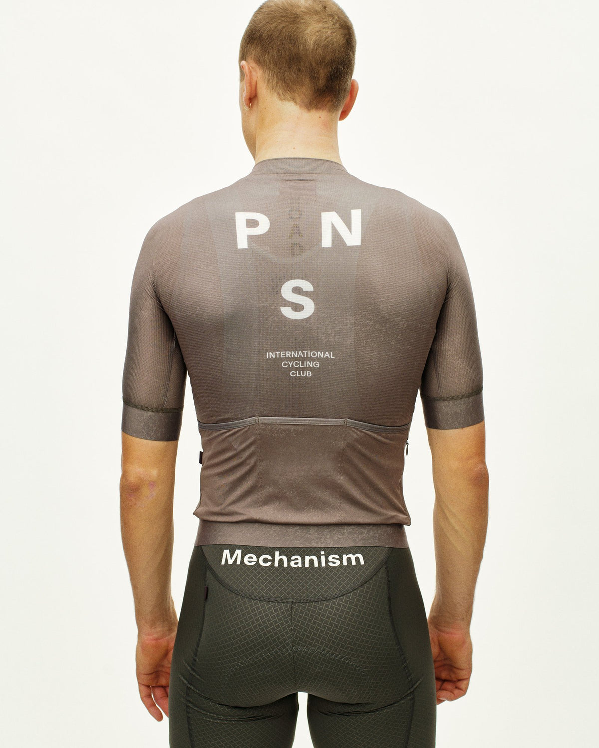 Maillot Corto Pas Normal Studios Mechanism en AOP Earth, vista trasera sobre ciclista #Color_AOP Earth