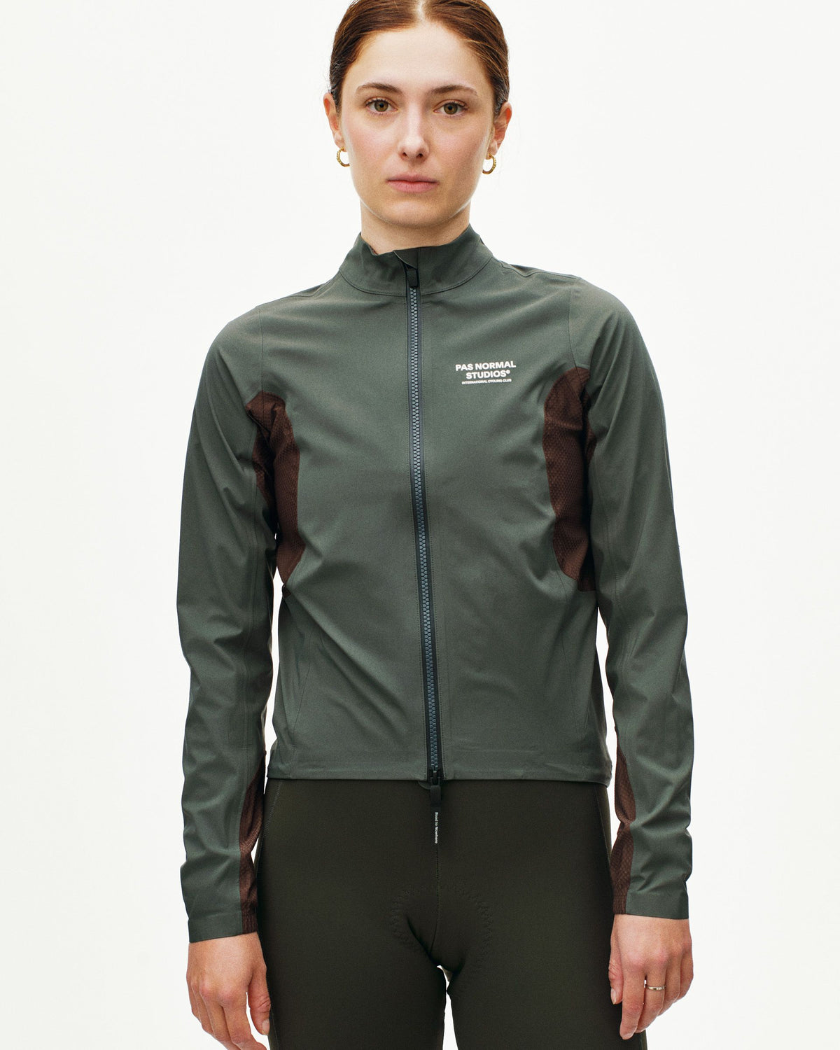 Dark Grey Mechanism Shell cycling jacket on model with mesh side panels #Color_Dark Grey