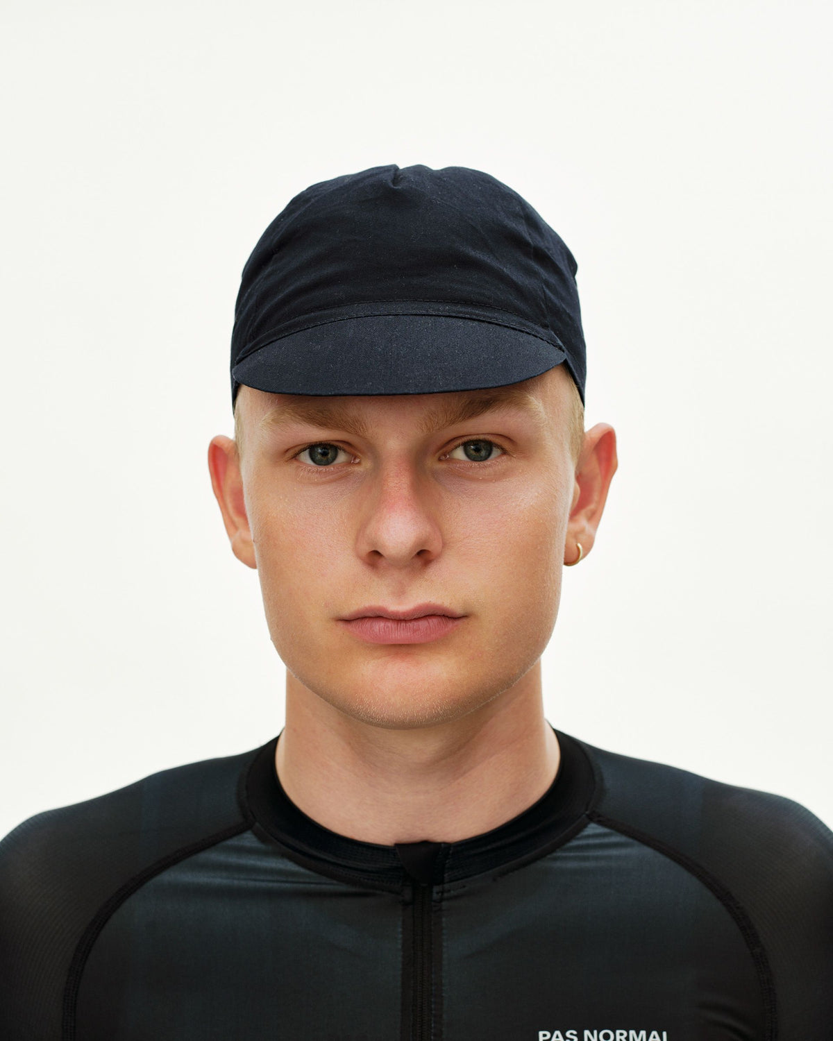 Black Logo Cap cycling cap on model, front view with short brim #Color_Black