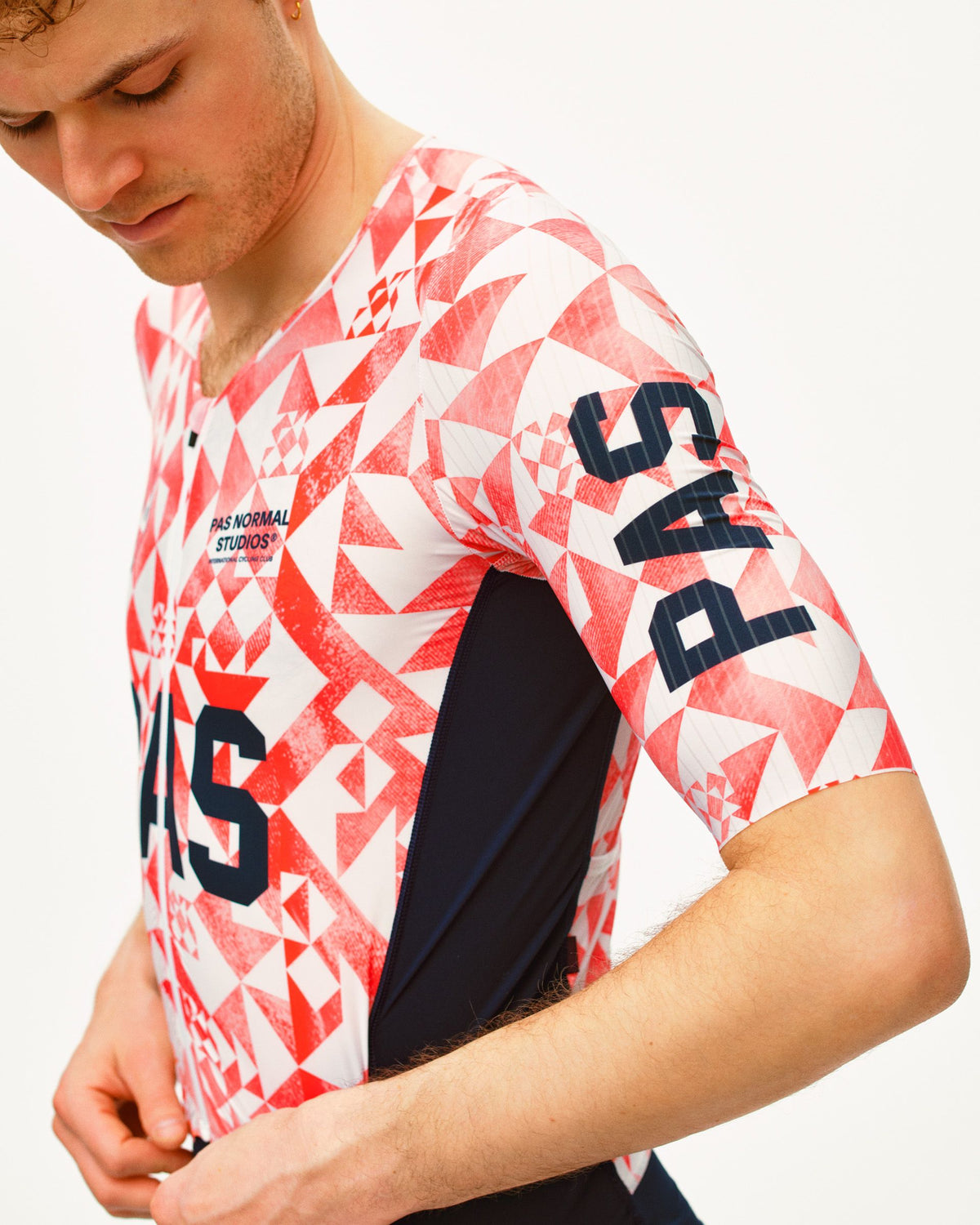 Red PAS Mechanism Pro Speedsuit on model with geometric origami print and black side panels #Color_Origami