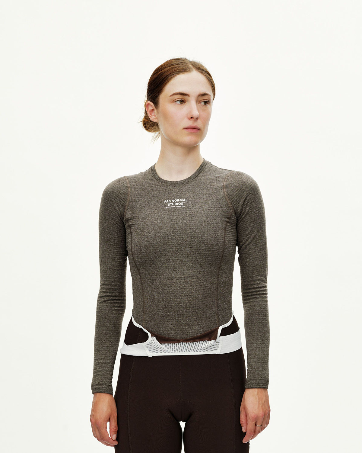 Dark Coffee brown Essential women's long sleeve cycling baselayer on model, front view with white chest logo print #Color_Dark Coffee