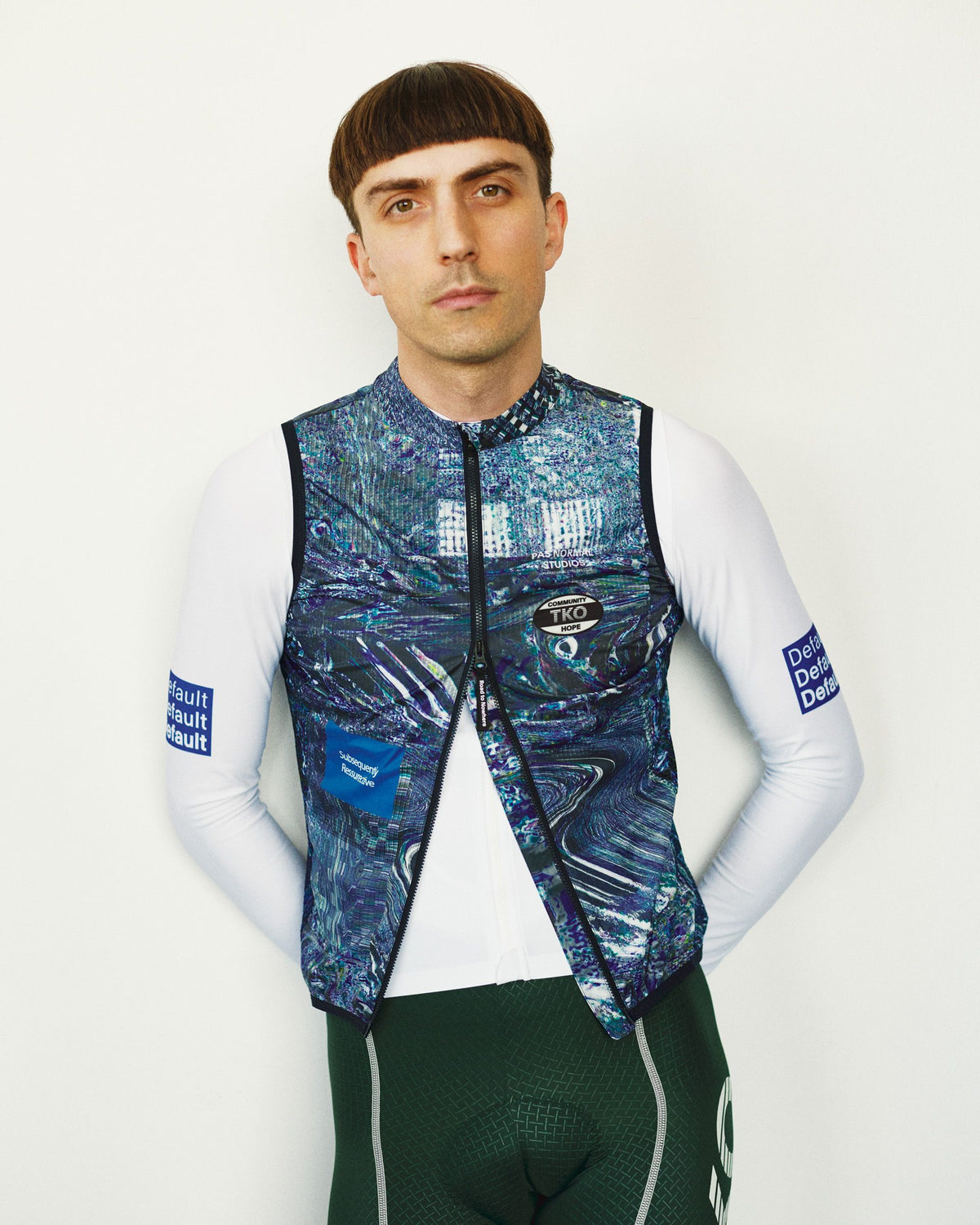 Human Error Blue T.K.O. Mechanism Stow Away cycling gilet on model, front view with abstract all-over print #Color_Human Error Blue