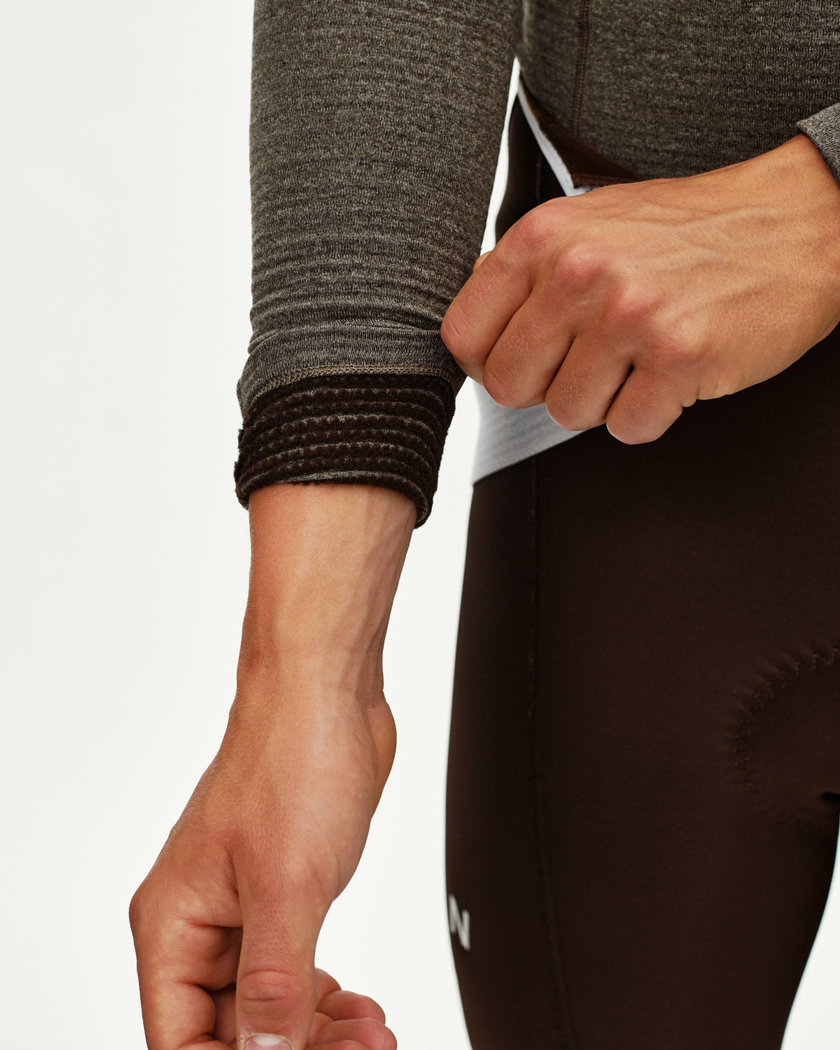 Dark Coffee brown Mechanism thermal long sleeve cycling base layer, detail view of ribbed cuff on model #Color_Dark Coffee