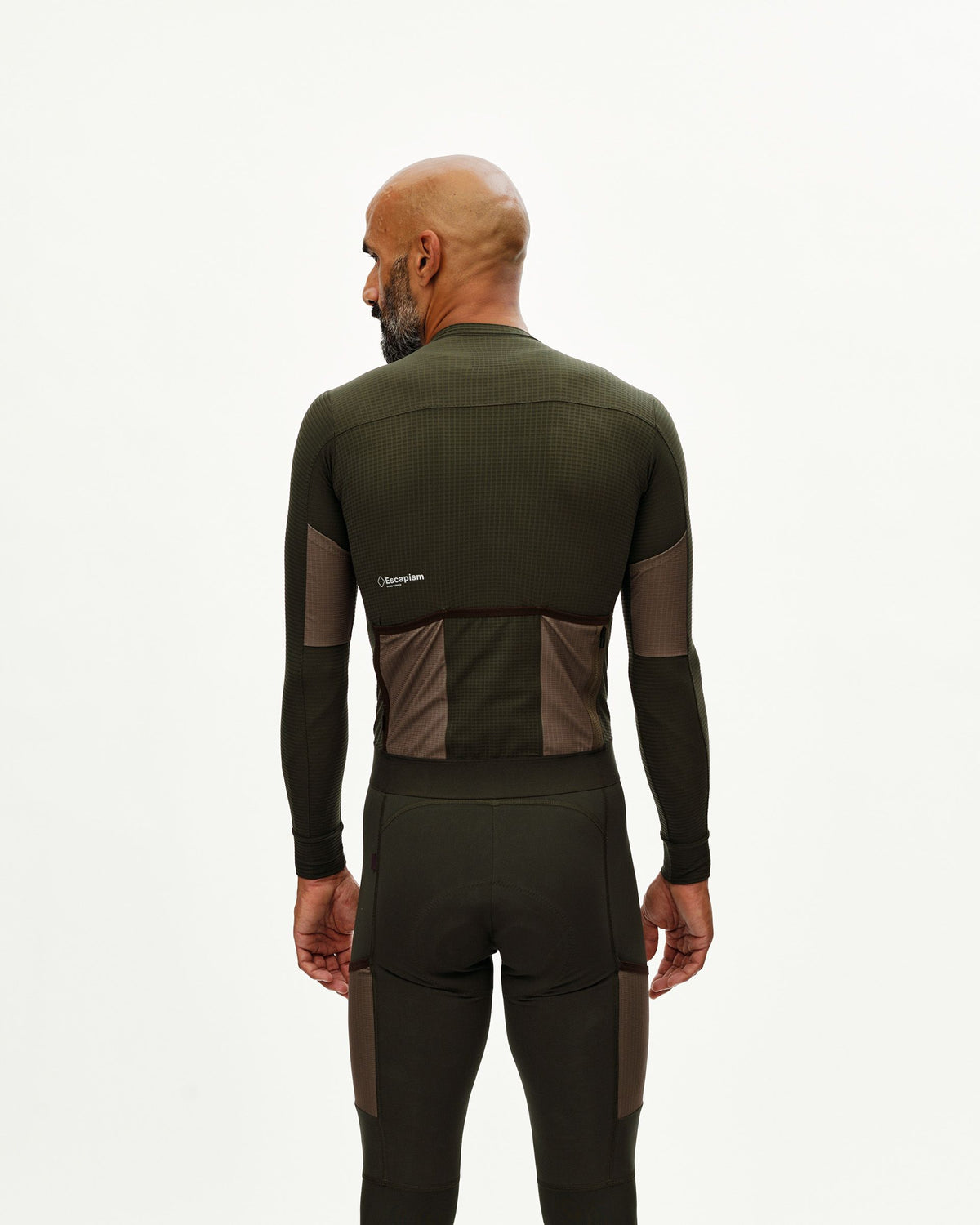 Maillot Largo Pas Normal Studios Escapism en Dark Olive, vista sobre ciclista #Color_Dark Olive