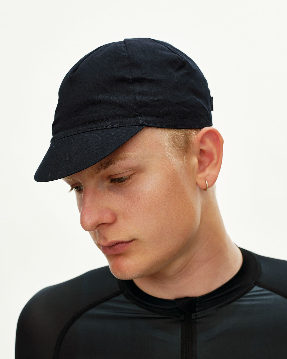 Black Logo Cap cycling cap on model, three-quarter front view with structured brim #Color_Black