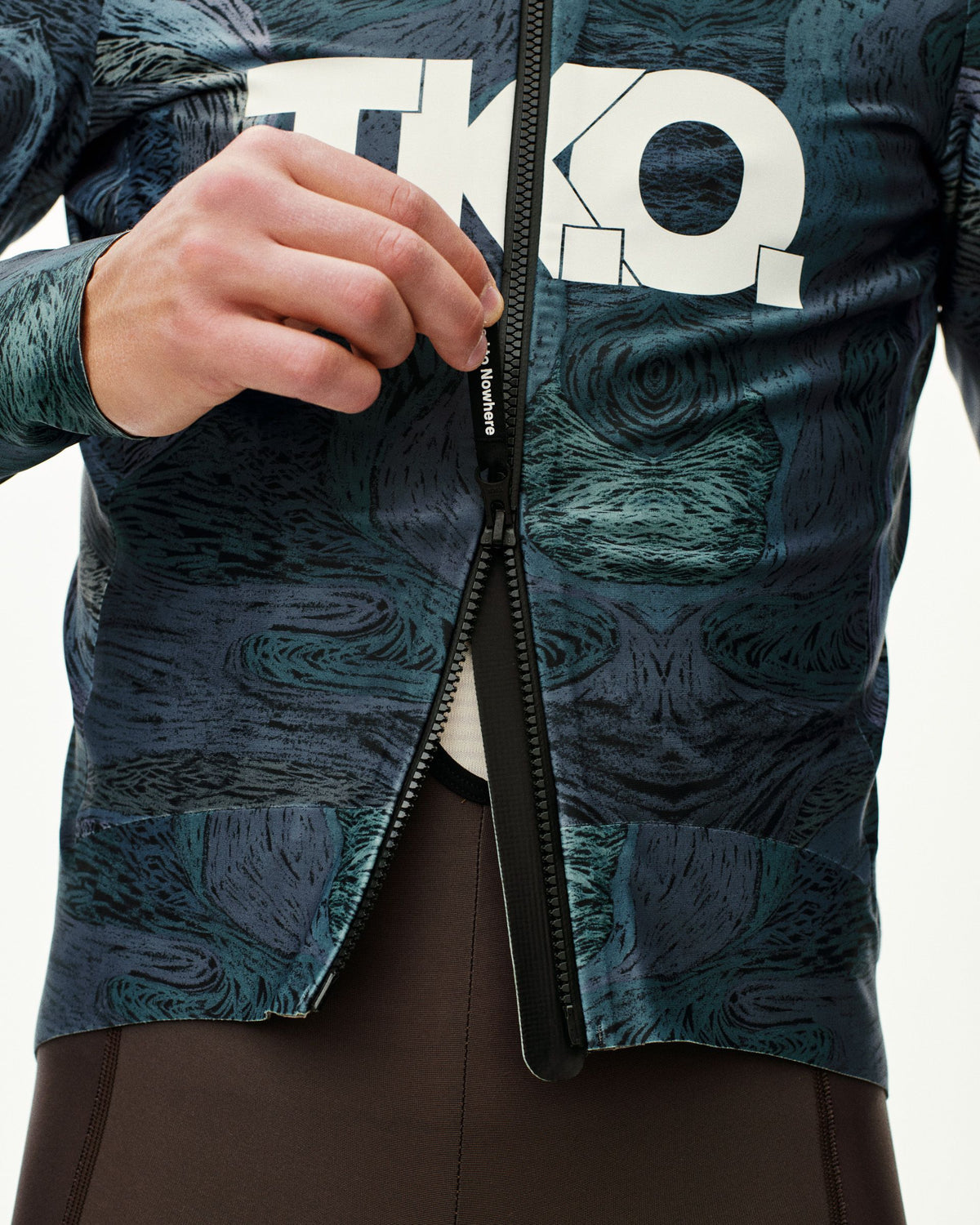 Dark Multi T.K.O. Mechanism Thermal cycling jacket, front detail on model with full zip open and allover print #Color_T.K.O. Dark Multi