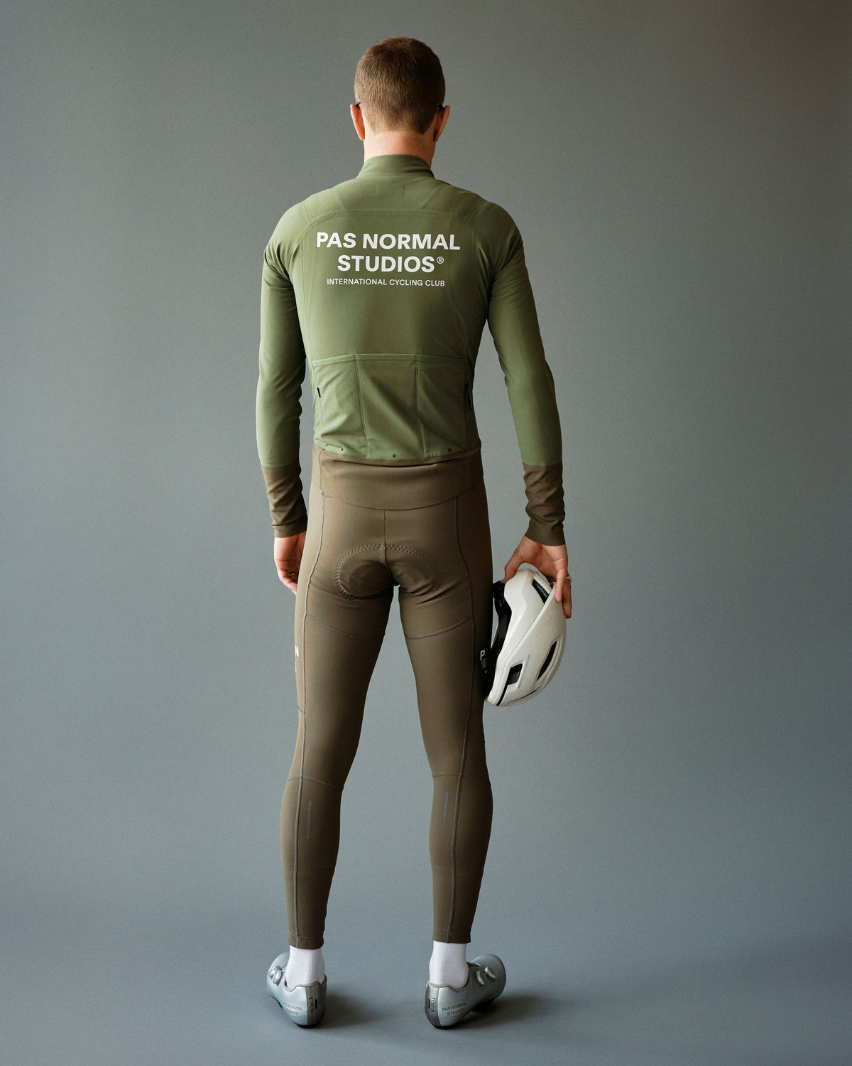 Green Mechanism Thermal cycling jacket on model, rear view with white logo print #Color_Army Green / Dark Stone