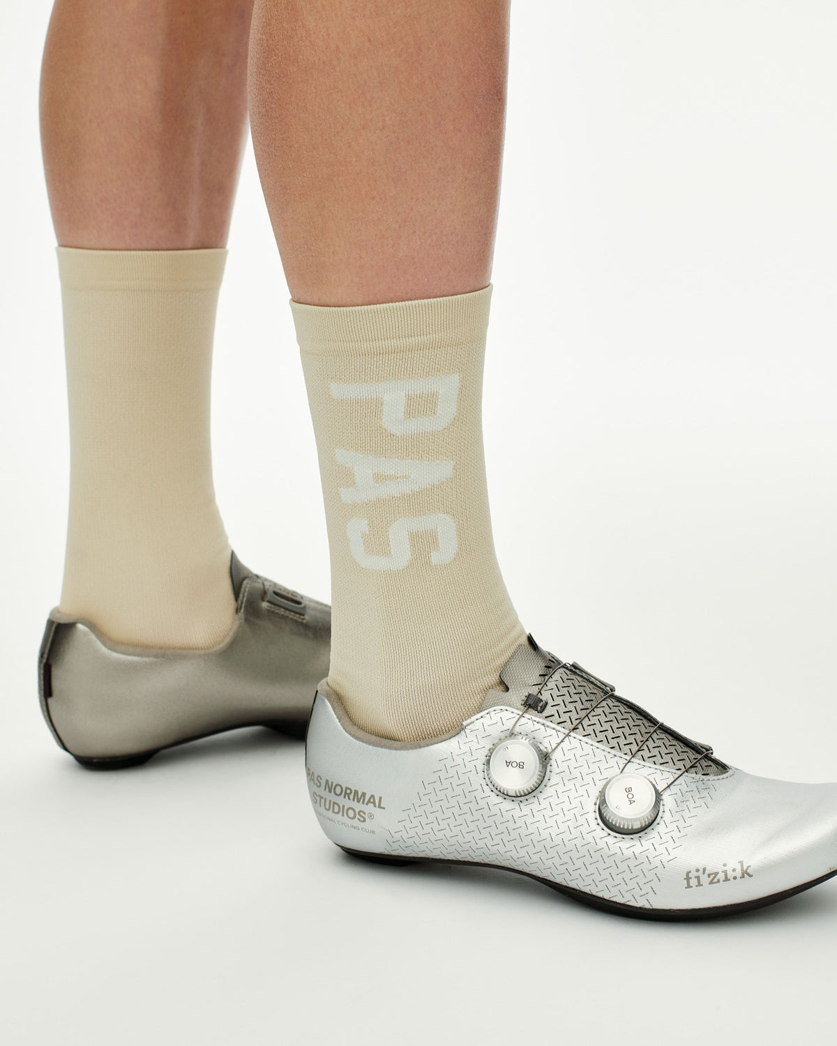 Cream PAS cycling socks on model with white PAS branding #Color_Cream