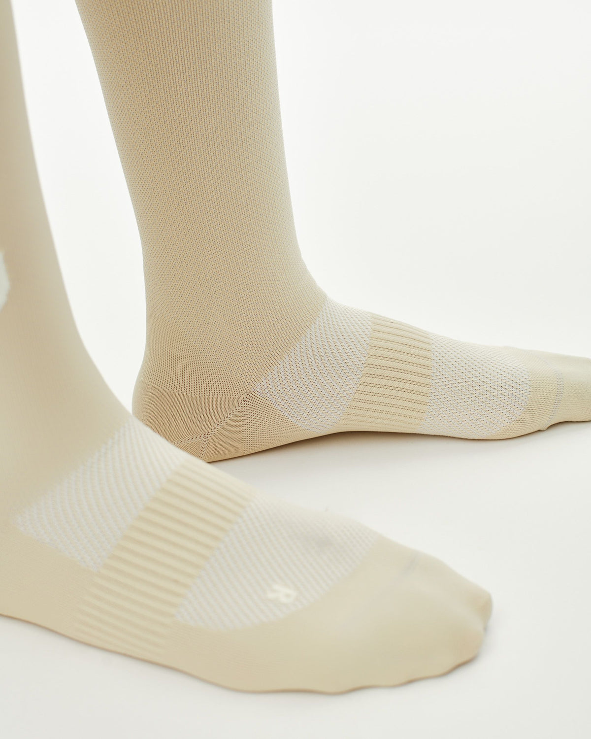 Cream PAS Race cycling socks on model with ribbed cuff and mesh foot panel #Color_Cream