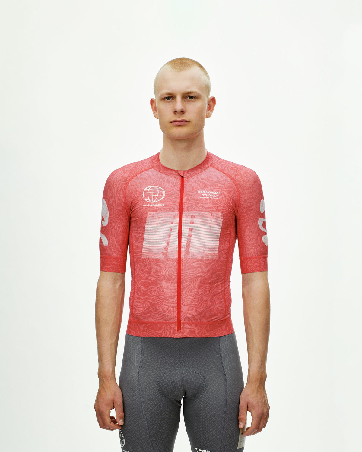 Maillot Corto Pas Normal Studios Mechanism Logo en AOP RTN Classic red, vista frontal sobre ciclista #Color_AOP RTN Classic red
