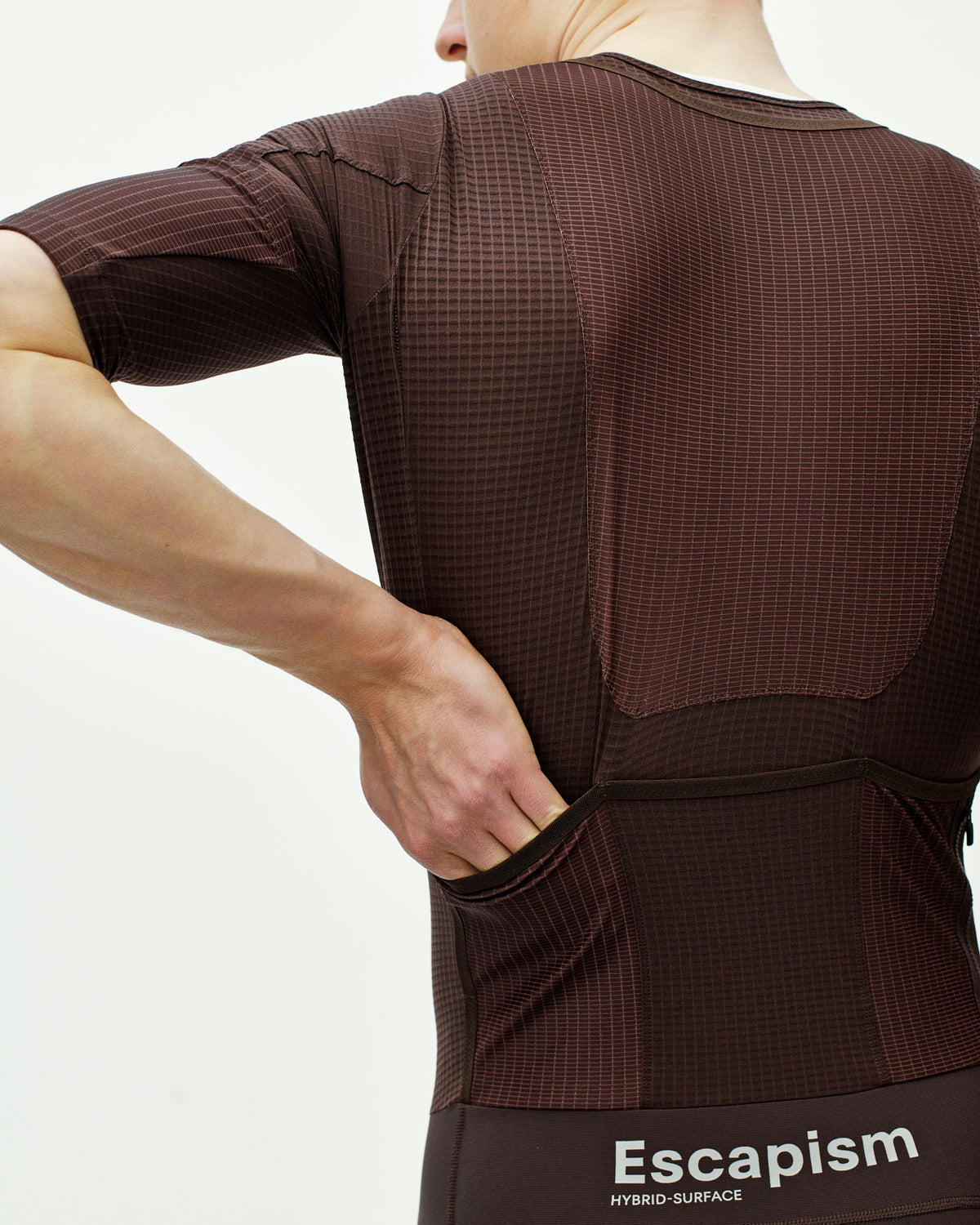Dark Red Escapism speedsuit on model, rear view with ripstop panels and rear pockets #Color_Dark Red
