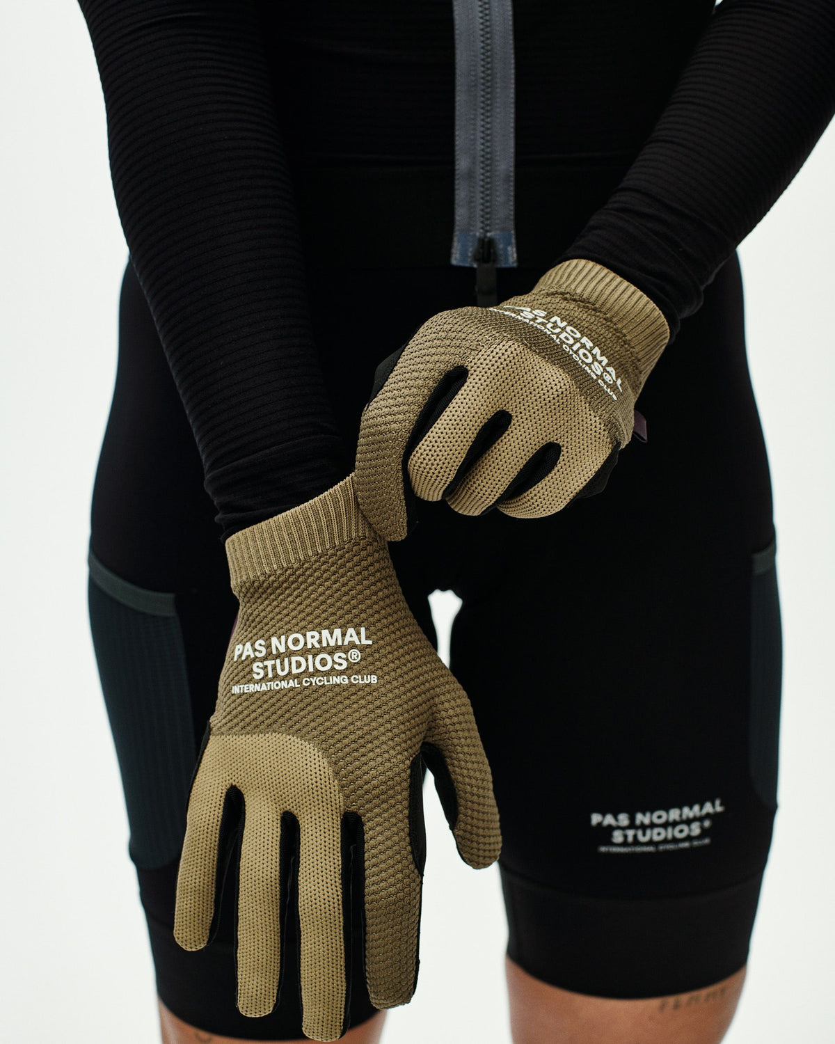 Brown Escapism cycling gloves on model with textured palm and white branding #Color_Earth