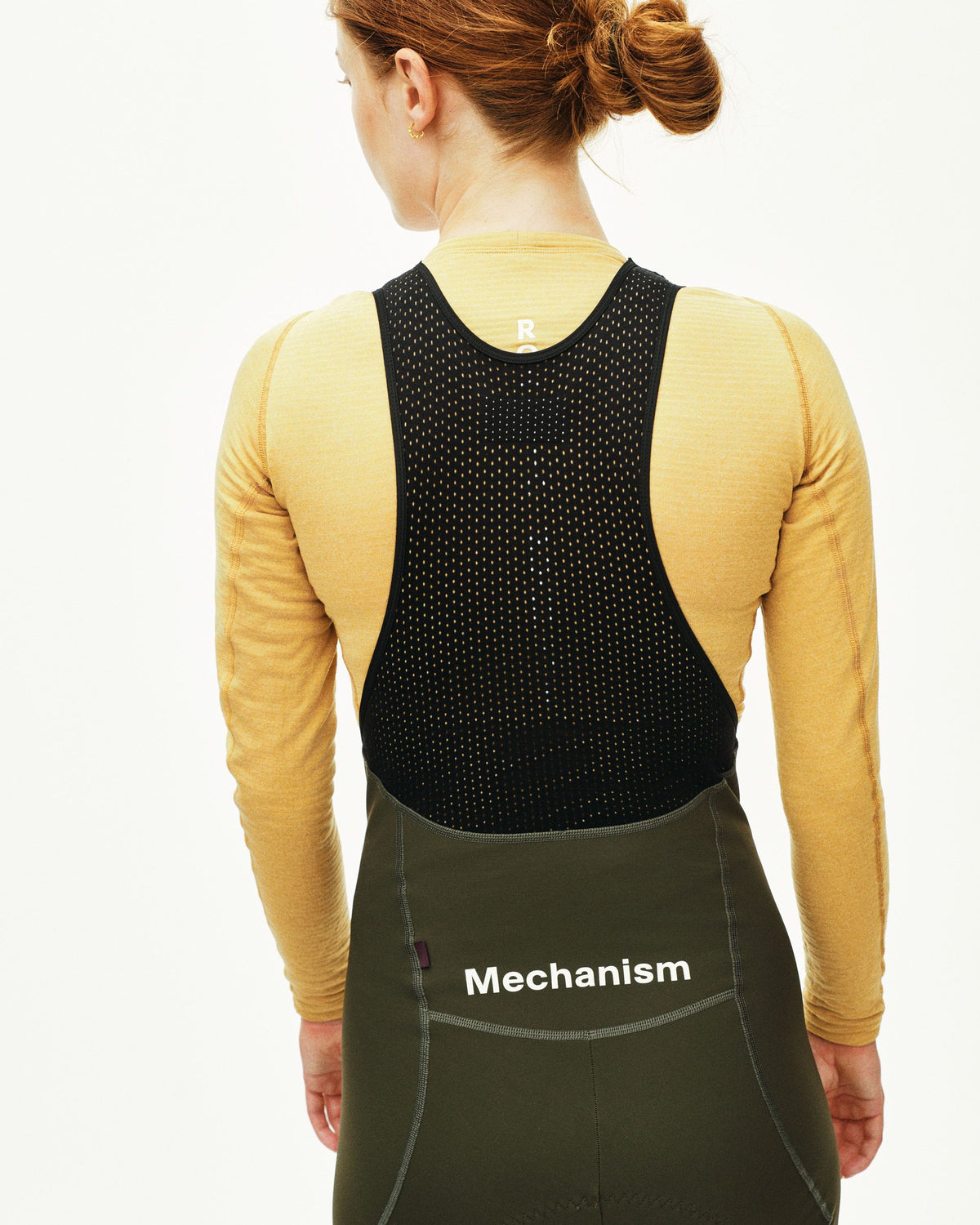 Camel Thermal Long Sleeve base layer on model, rear view with black mesh vest overlay #Color_Camel