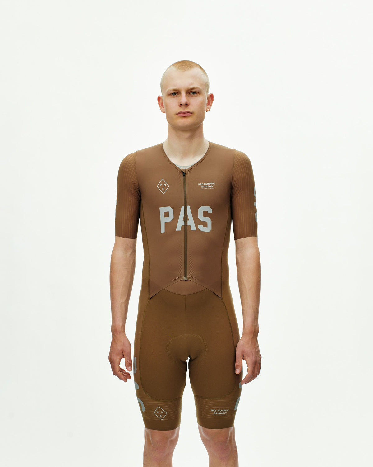 Brown PAS Mechanism Pro speedsuit on model, front view with white chest logo #Color_Brown
