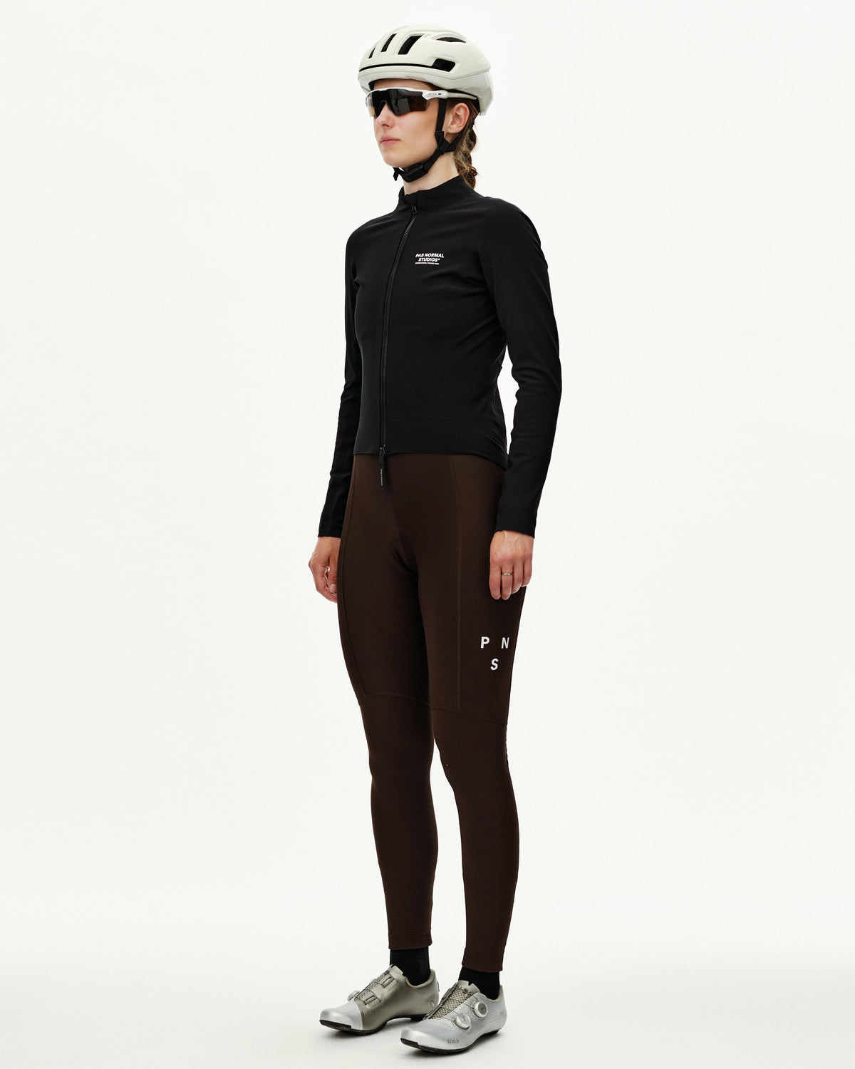Black Mechanism women's thermal cycling jacket on model, three-quarter front view with full zip and chest logo print #Color_Black