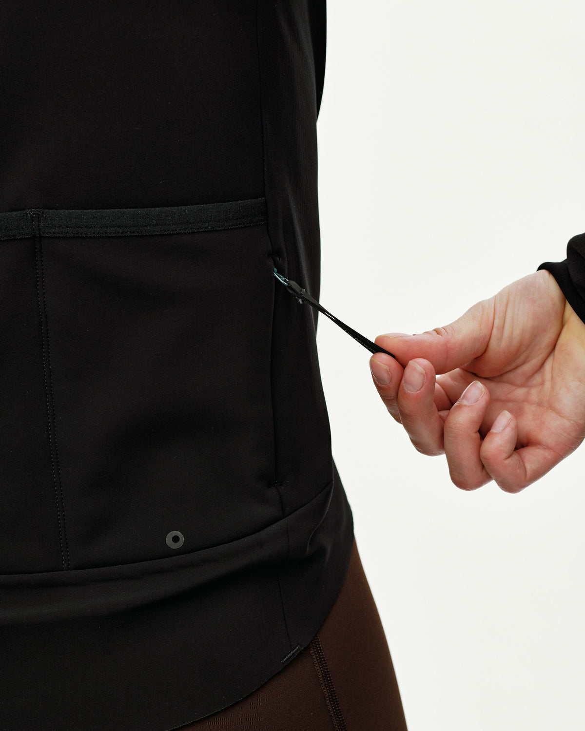 Black Mechanism Thermal cycling jacket, side detail on model showing zip pocket pull #Color_Black