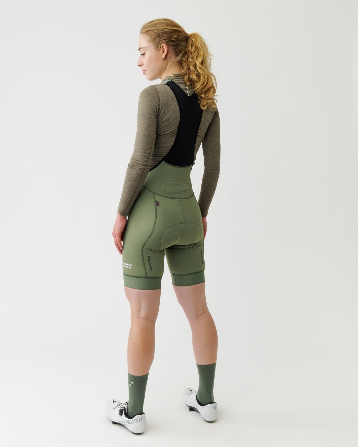 Dark Stone Thermal Long Sleeve base layer on model, rear three-quarter view with black vest overlay #Color_Dark Stone
