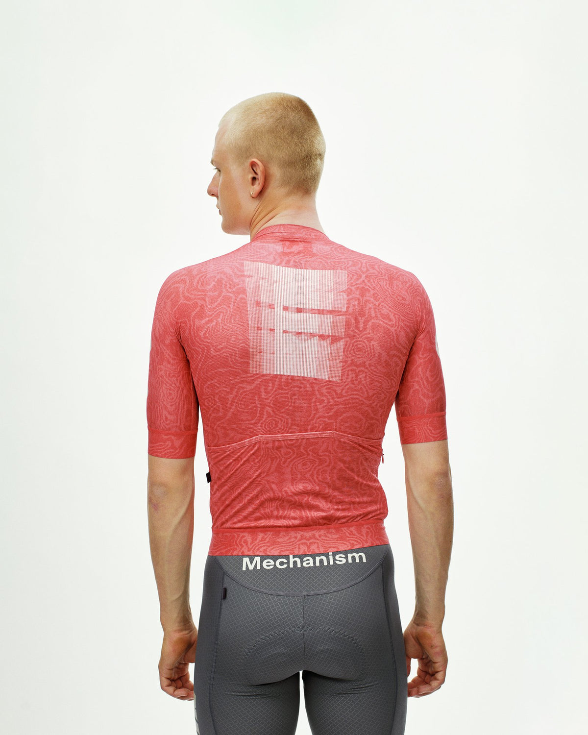 Maillot Corto Pas Normal Studios Mechanism Logo en AOP RTN Classic red, vista trasera sobre ciclista #Color_AOP RTN Classic red